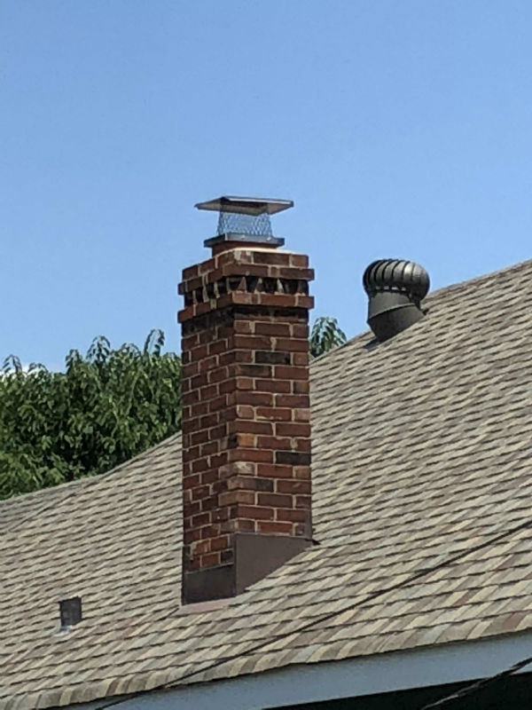 masonry chimney with mesh metal cap